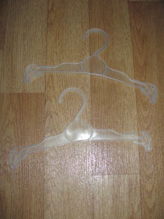 twee doorzichtige poppenkleding hangertjes